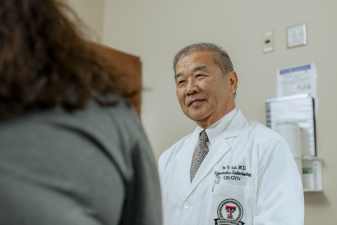 Dr. Bo Y Suh, M.D. consults with a patient