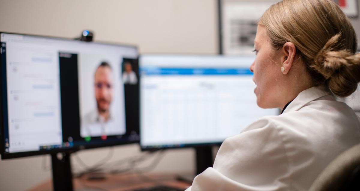 Medical provider speaking with a patient during a virtual dermatology visit using telehealth technology