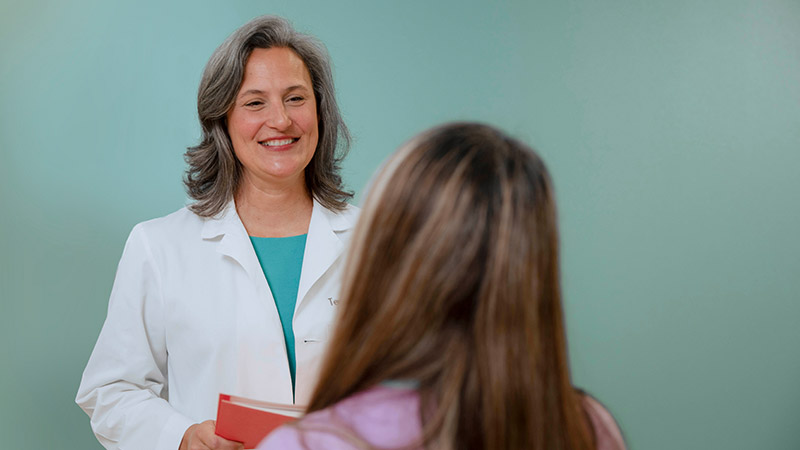 provider standing in front of employee smiling