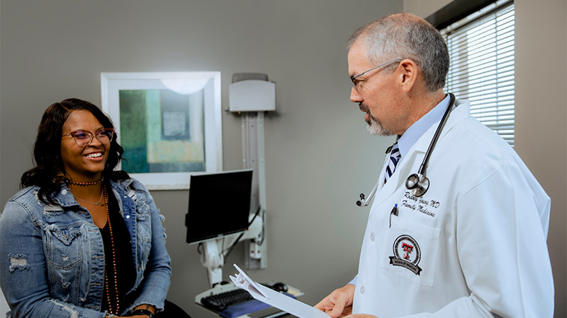 Doctor talking to patient with smiling faces