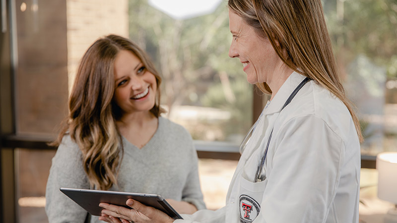 Patient looking at provider smiling.