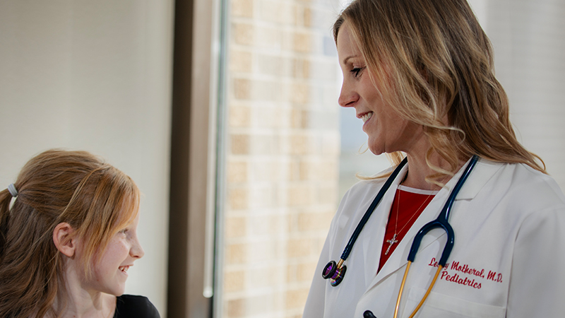 Provider with stethoscope standing in front of Pedi patient