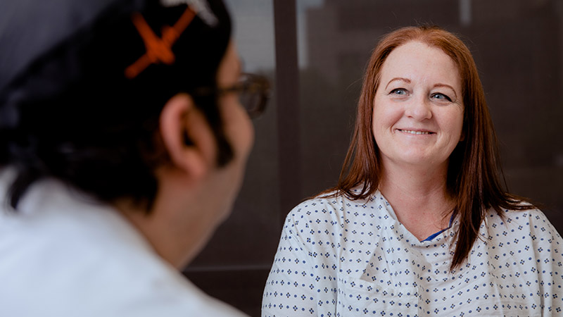 Provider speaking to patient and her smiling sitting 