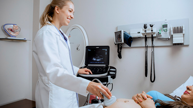 Provider performing an ultrasound on a patient
